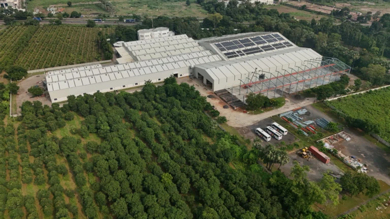 Aerial view of Axtel Industries Shed 2 under construction beside the completed Shed 1, Vadodara, Gujarat