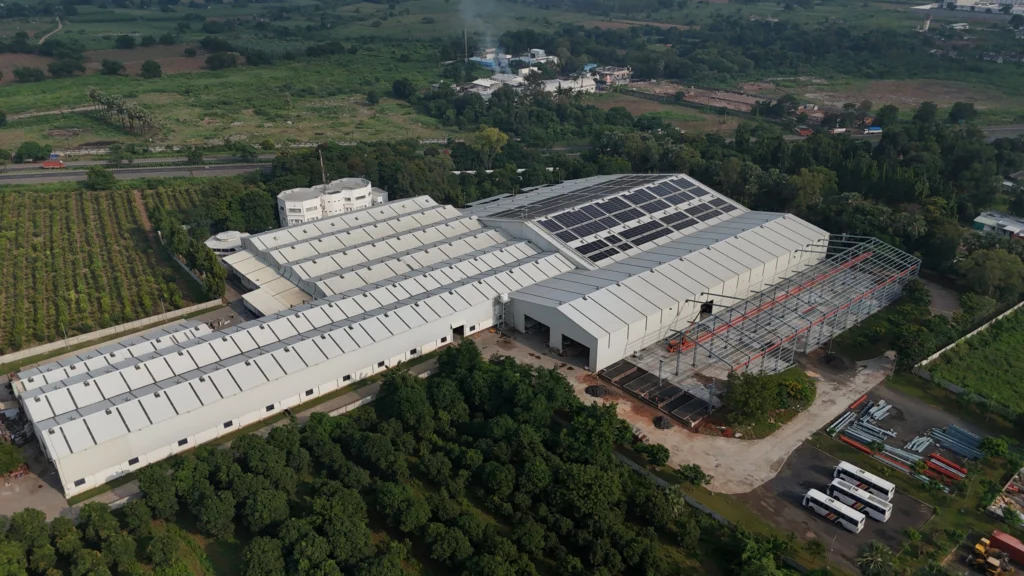 Aerial view of Axtel Industries Shed 2 under construction beside the completed Shed 1, Vadodara, Gujarat