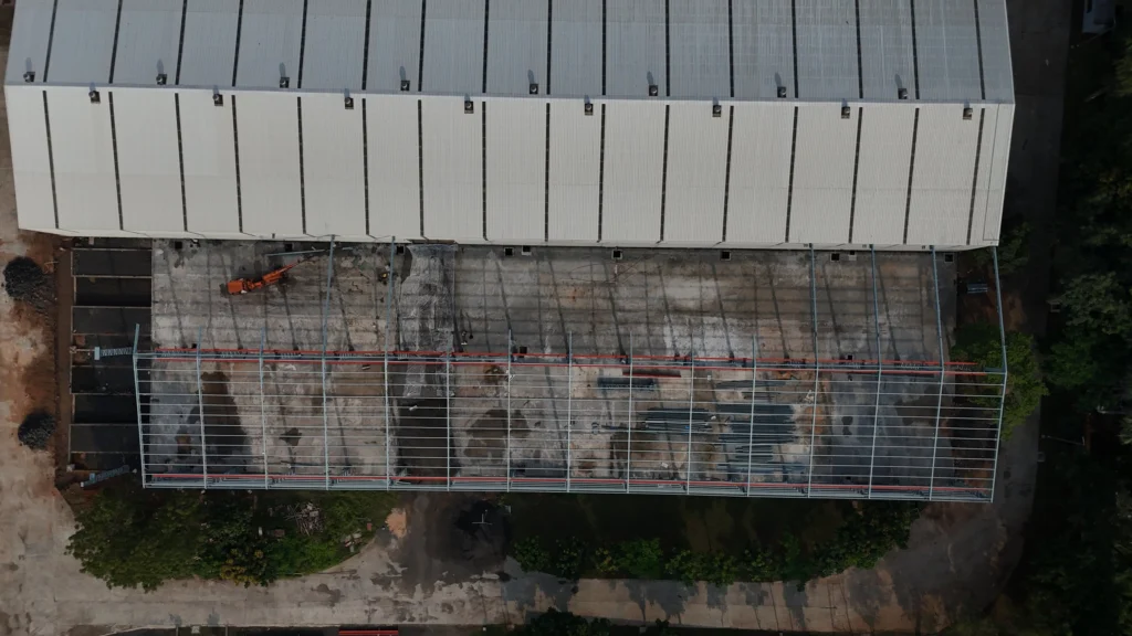 Aerial view of Axtel Industries Shed 2 under construction beside the completed Shed 1, Vadodara, Gujarat