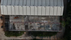 Aerial view of Axtel Industries Shed 2 under construction beside the completed Shed 1, Vadodara, Gujarat