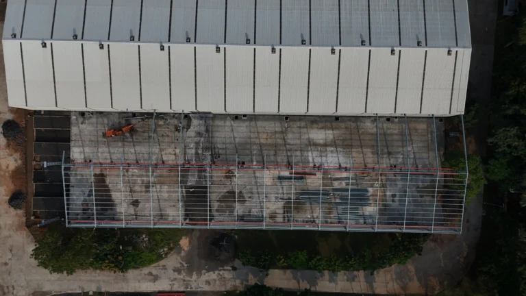 Aerial view of Axtel Industries Shed 2 under construction beside the completed Shed 1, Vadodara, Gujarat