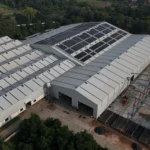 Aerial view of Axtel Industries Shed 2 under construction beside the completed Shed 1, Vadodara, Gujarat