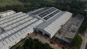 Aerial view of Axtel Industries Shed 2 under construction beside the completed Shed 1, Vadodara, Gujarat
