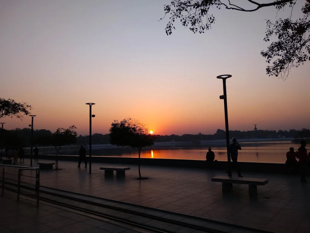 Lakeside promenade with lamp posts at sunrise